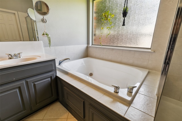 bathroom with vanity, tile patterned floors, and plus walk in shower