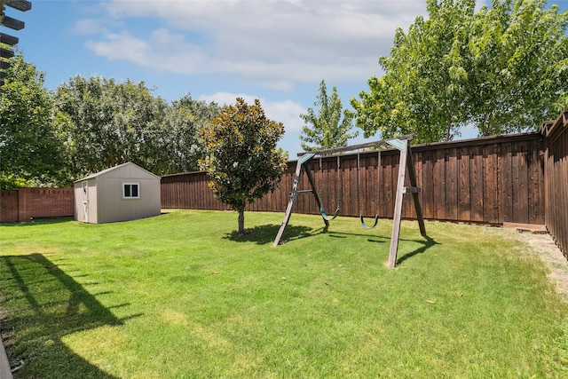 view of yard with a storage shed and a playground