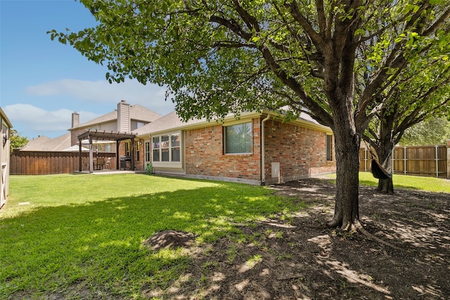 rear view of property featuring a patio and a yard