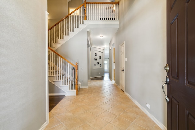 tiled foyer with a high ceiling