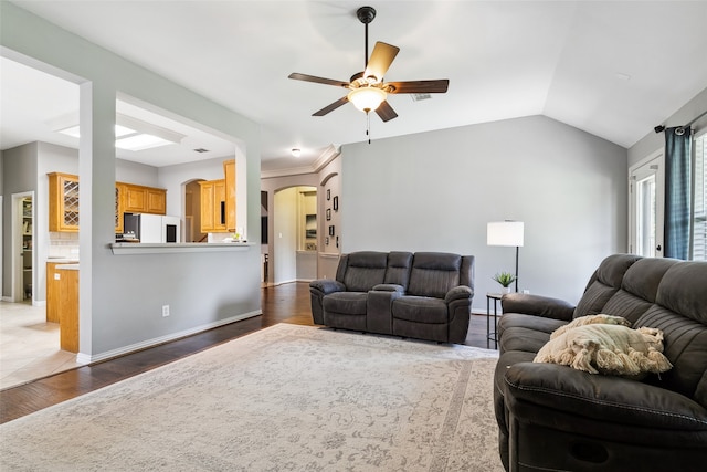 living room featuring ceiling fan, lofted ceiling, and dark hardwood / wood-style floors