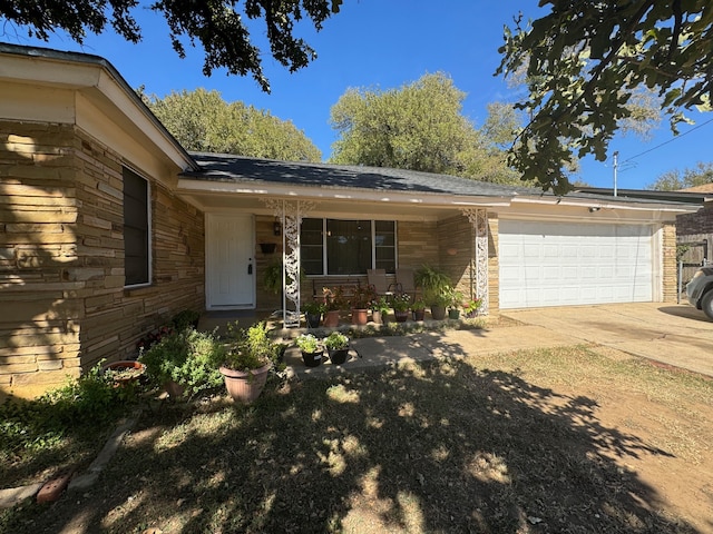 ranch-style home with covered porch and a garage