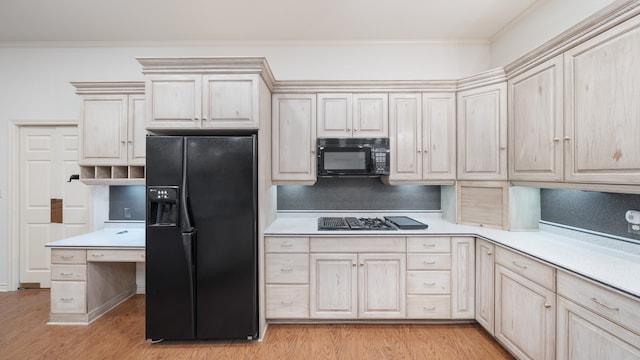 kitchen featuring black appliances, crown molding, and light hardwood / wood-style floors