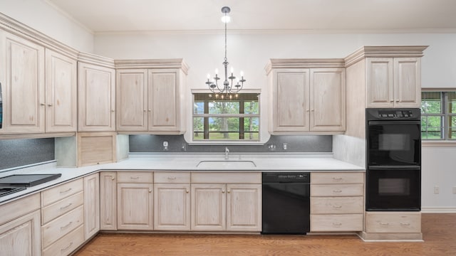 kitchen with sink, black appliances, light wood-type flooring, a chandelier, and tasteful backsplash