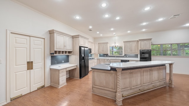 kitchen with light hardwood / wood-style floors, sink, an island with sink, and refrigerator with ice dispenser