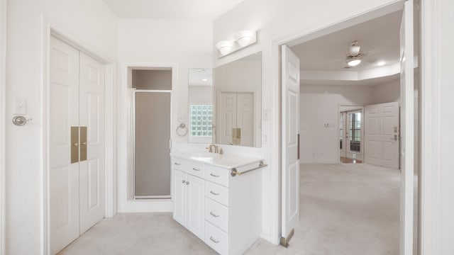 bathroom featuring vanity, ceiling fan, and a shower with shower door