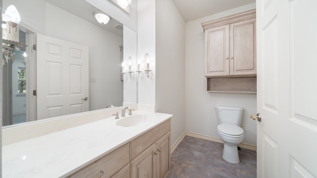 bathroom with toilet and vanity