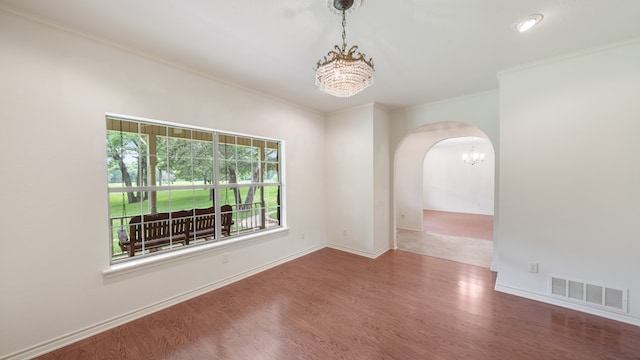 spare room featuring ornamental molding and hardwood / wood-style floors