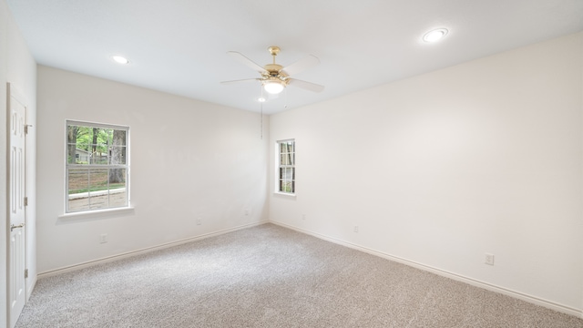 carpeted empty room featuring ceiling fan