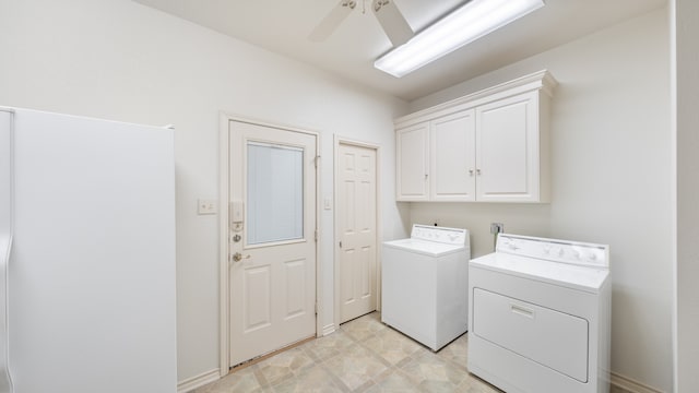 clothes washing area featuring ceiling fan, washing machine and clothes dryer, and cabinets