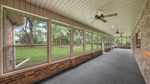 unfurnished sunroom with ceiling fan and a wealth of natural light