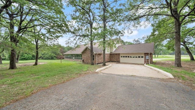 view of front of home with a front lawn and a garage