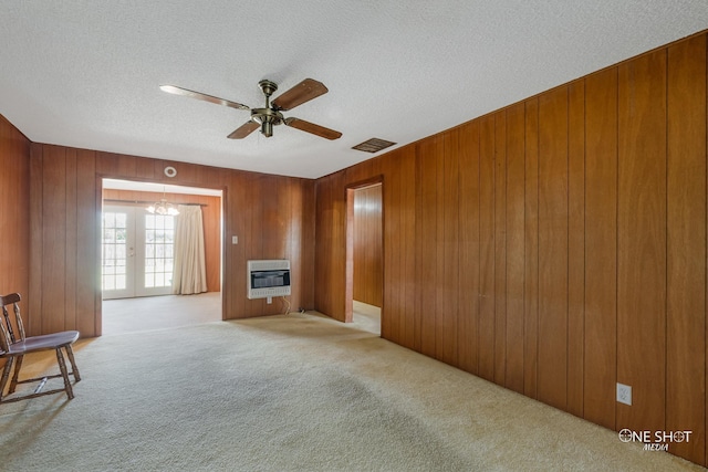 living room featuring french doors, a textured ceiling, heating unit, light colored carpet, and ceiling fan