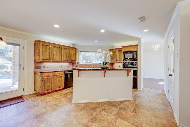 kitchen with black appliances, crown molding, a kitchen island, backsplash, and a kitchen breakfast bar