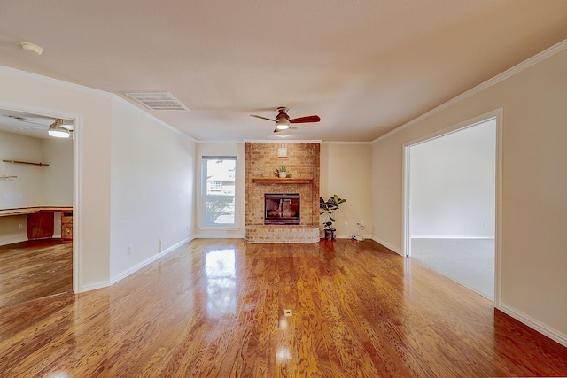 unfurnished living room with a fireplace, wood-type flooring, and crown molding