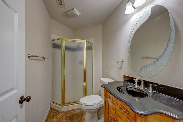 bathroom with a shower with shower door, vanity, toilet, and tile patterned flooring