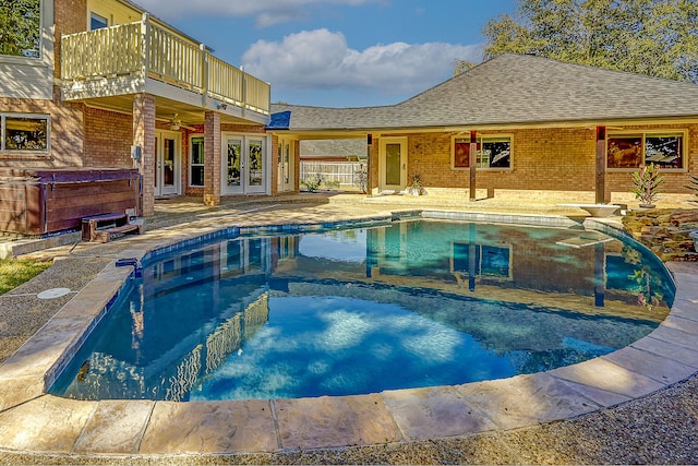 view of pool featuring a patio, a hot tub, and french doors