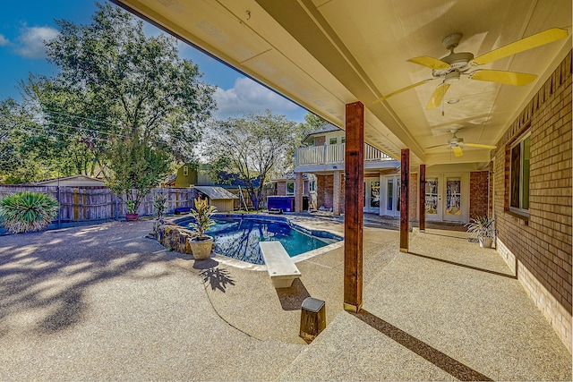 view of pool featuring french doors, ceiling fan, and a patio