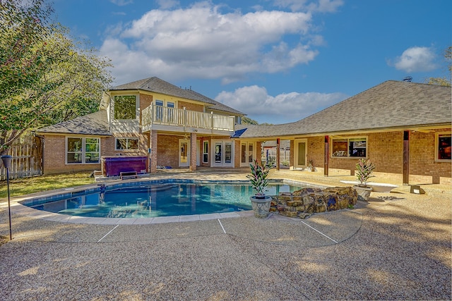 view of swimming pool with a hot tub and a patio