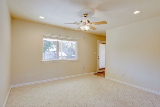 carpeted empty room featuring ceiling fan