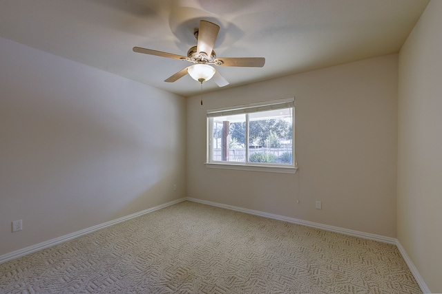 empty room featuring light carpet and ceiling fan