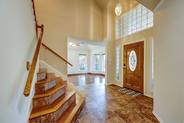 entryway featuring a high ceiling and ceiling fan