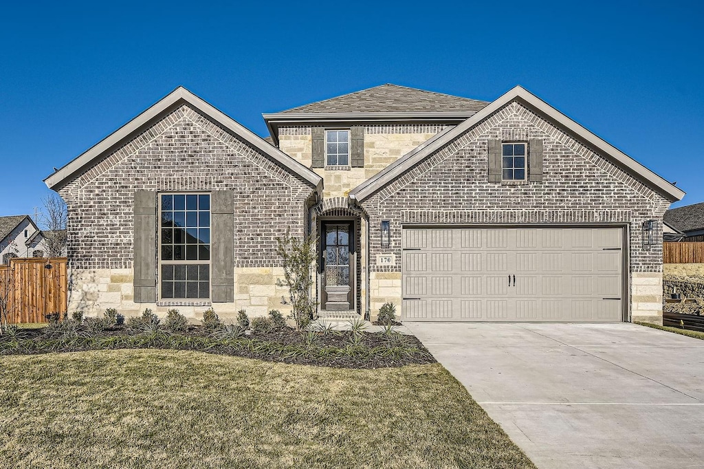 view of front property with a garage and a front lawn