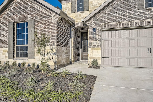 view of exterior entry with a garage