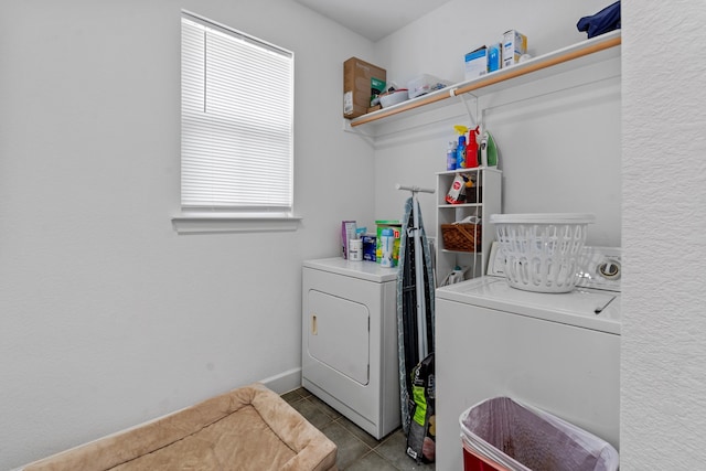 clothes washing area featuring light tile patterned flooring, separate washer and dryer, and a wealth of natural light