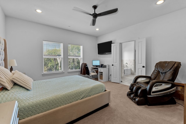 bedroom with light carpet, connected bathroom, and ceiling fan