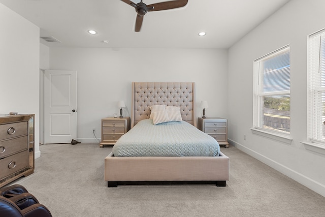 bedroom with ceiling fan and light carpet