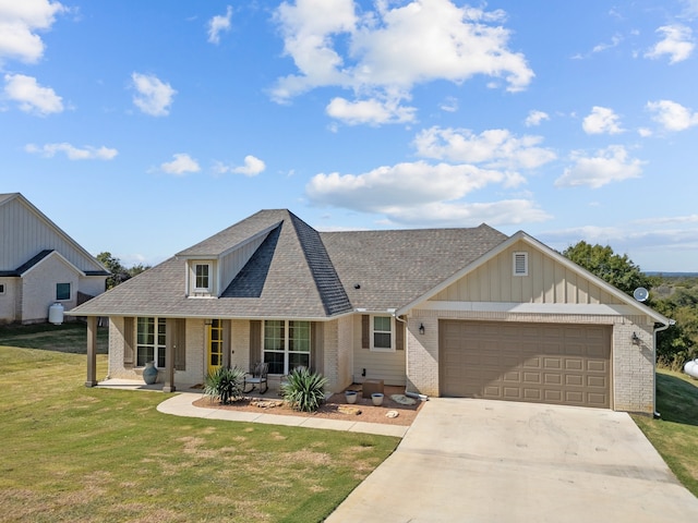 view of front of house featuring a porch, a garage, and a front lawn