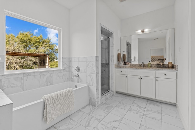 bathroom featuring plus walk in shower and vanity