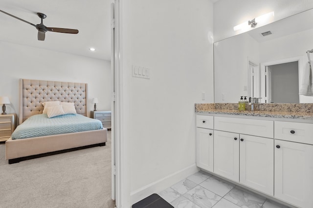 bathroom with ceiling fan and vanity