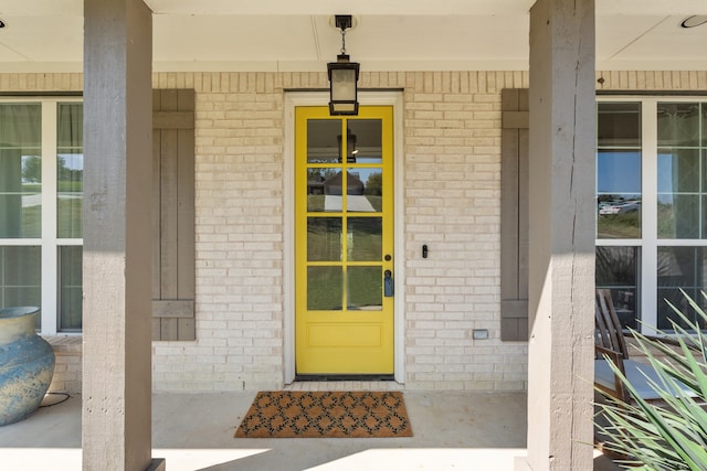 view of exterior entry with covered porch