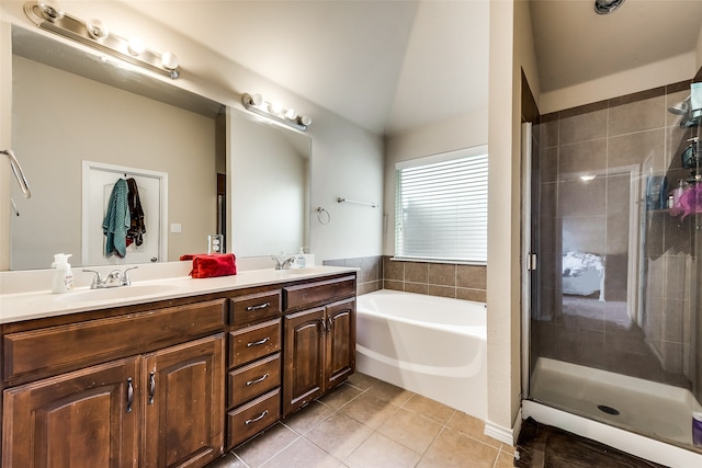 bathroom featuring vanity, lofted ceiling, plus walk in shower, and tile patterned floors