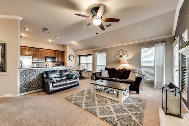 carpeted living room featuring ceiling fan, ornamental molding, and lofted ceiling