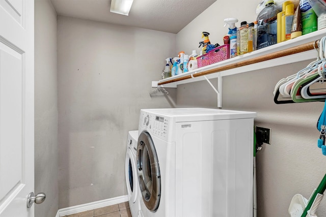 laundry room featuring light tile patterned flooring, independent washer and dryer, and a textured ceiling