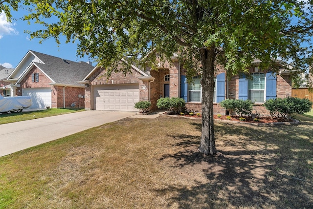 view of front of house with a front yard and a garage