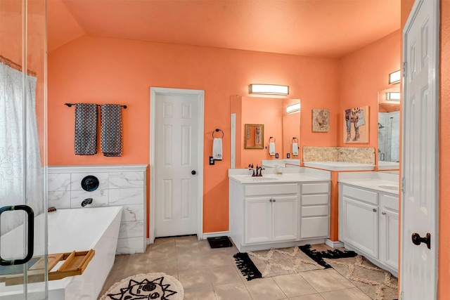 bathroom with lofted ceiling, tile patterned flooring, independent shower and bath, vanity, and tile walls