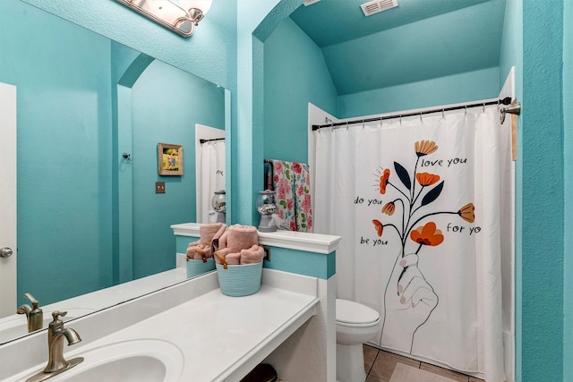 bathroom featuring vanity, tile patterned floors, and toilet