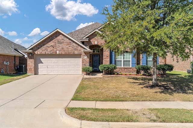 view of front of home with a front yard, a garage, and central air condition unit