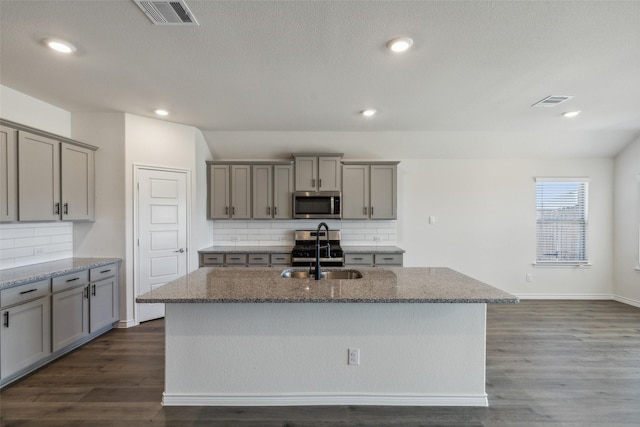 kitchen featuring an island with sink, dark hardwood / wood-style floors, and sink