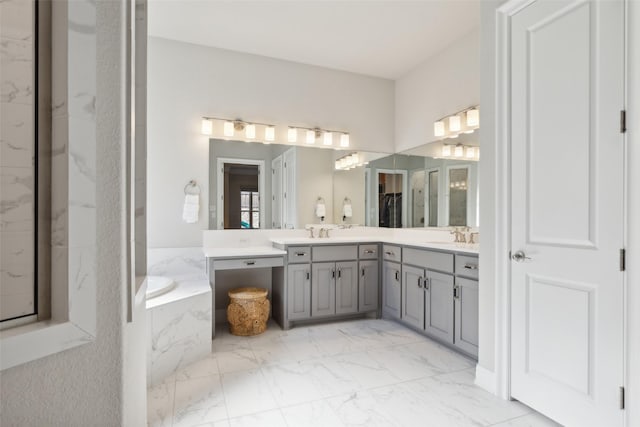 bathroom with a relaxing tiled tub and vanity