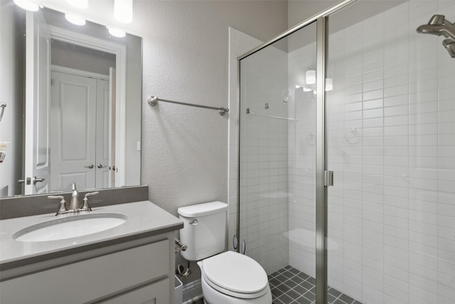 bathroom featuring vanity, an enclosed shower, and toilet