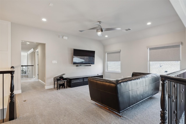 carpeted living room with ceiling fan