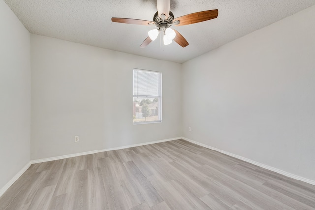 unfurnished room with ceiling fan, a textured ceiling, and light wood-type flooring