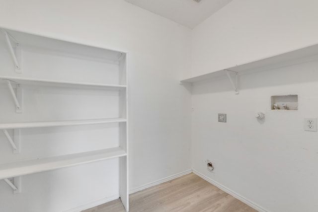 laundry room with electric dryer hookup, light hardwood / wood-style flooring, gas dryer hookup, and washer hookup