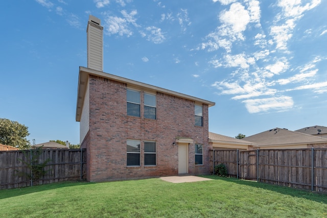 rear view of property with a patio area and a lawn