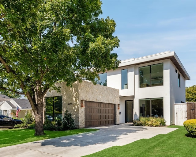 view of front of property with a garage and a front lawn